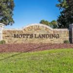 Mott's Landing community entrance sign brick with brown text lettering
